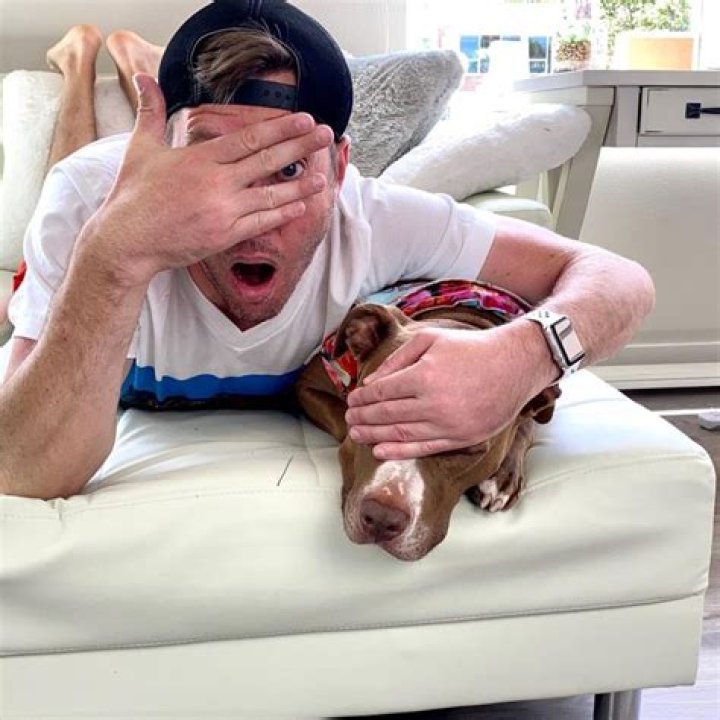 Robby Cole having fun with hsi pet